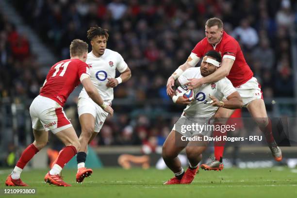 Manu Tuilagi of England is tackled by Hadleigh Parkes of Wales during the 2020 Guinness Six Nations match between England and Wales at Twickenham...