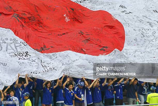 Supporters hoist a giant Japanese flag, spread over the bleechers of Osaka Nagai Stadium, 14 June, 2002 before match 45 group H of the 2002 FIFA...