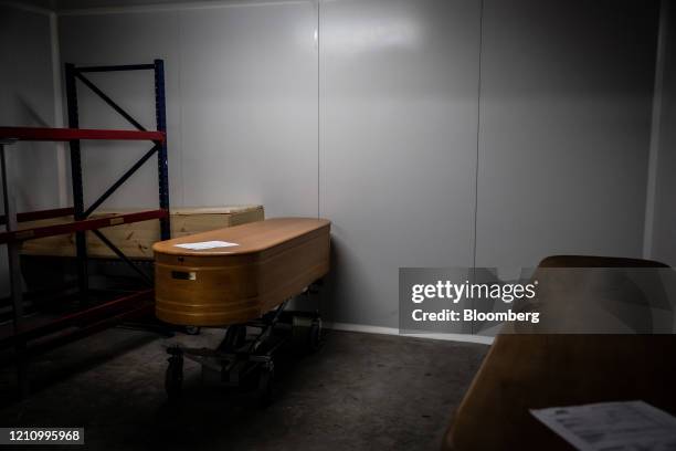 Caskets containing the victims of coronavirus stand inside a cold storage room in the mortuary at Servicios Funerarios SL funeral home, in Girona,...