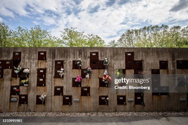 Floral tributes to the deceased hang from a columbarium at the Memora Servicios Funerarios SL funeral home in Girona, Spain, on Thursday, April 23,...