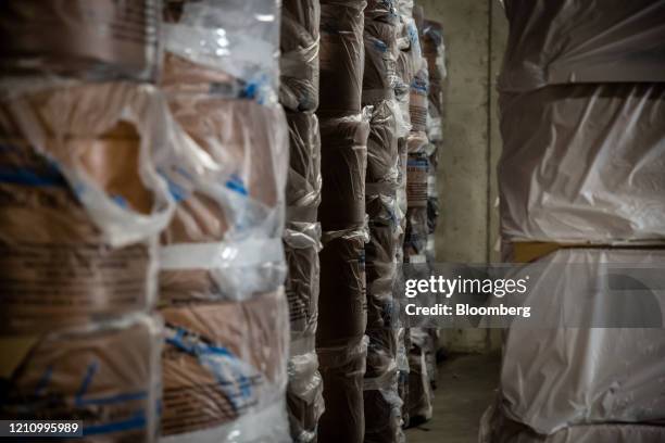 Empty caskets sit in protective wrappings in a storage area at the mortuary in the Memora Servicios Funerarios SL funeral home in Girona, Spain, on...