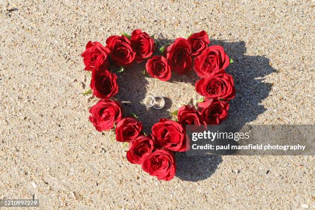 wedding rings and heart shaped bunch of roses - ring shaped stock pictures, royalty-free photos & images