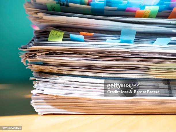 pile of papers on a work table. - catasta foto e immagini stock