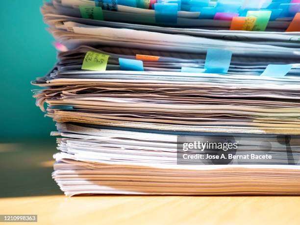 pile of papers on a work table. - wooden sign post stockfoto's en -beelden