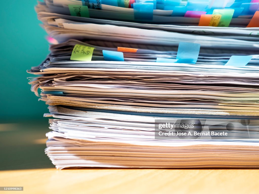 Pile of papers on a work table.