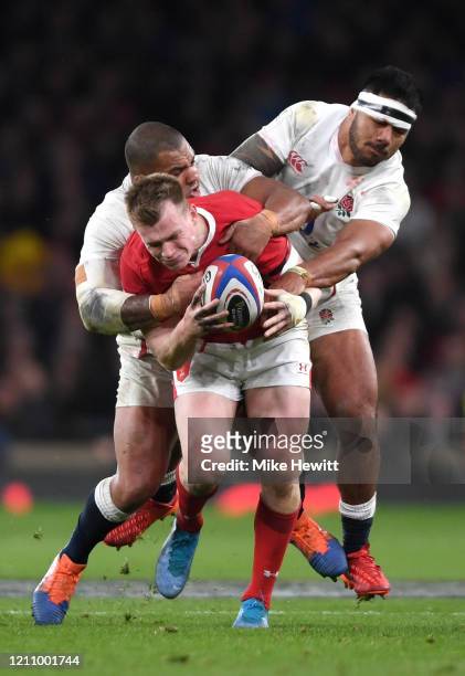 Nick Tompkins of Wales is tackled by Kyle Sinckler and Manu Tuilagi of England during the 2020 Guinness Six Nations match between England and Wales...