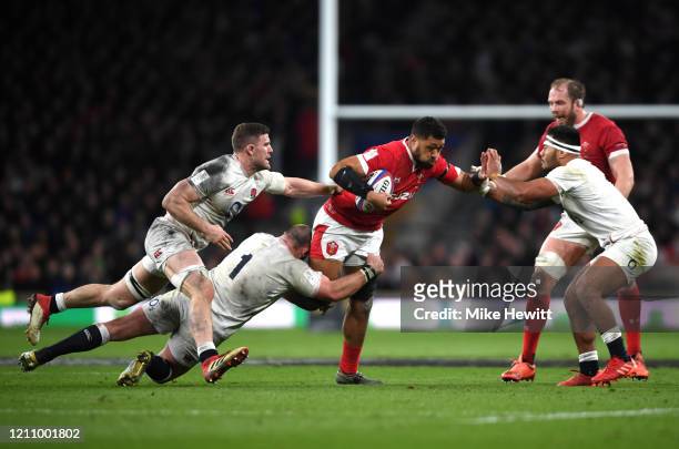 Taulupe Faletau of Wales is tackled by Joe Marler, Manu Tuilagi and Mark Wilson of England during the 2020 Guinness Six Nations match between England...
