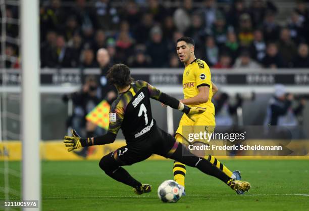 Achraf Hakimi of Borussia Dortmund scores his team's second goal during the Bundesliga match between Borussia Moenchengladbach and Borussia Dortmund...