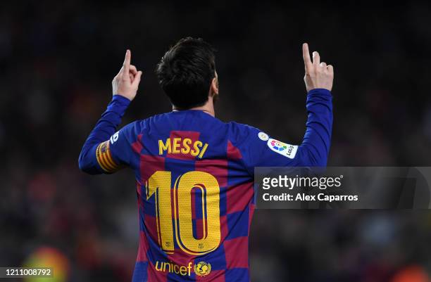 Lionel Messi of FC Barcelona celebrates after scoring his team's first goal during the La Liga match between FC Barcelona and Real Sociedad at Camp...
