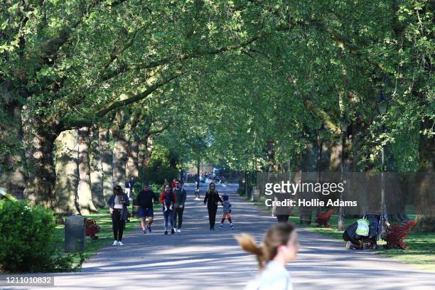People get their daily exercise in Battersea Park on April 25, 2020 in London, United Kingdom. The British government has extended the lockdown...