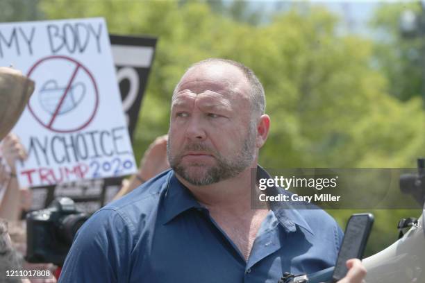 Alex Jones speaks to protestors gathered outside the Texas State Capitol during a rally calling for the reopening of Austin and Texas on April 25,...