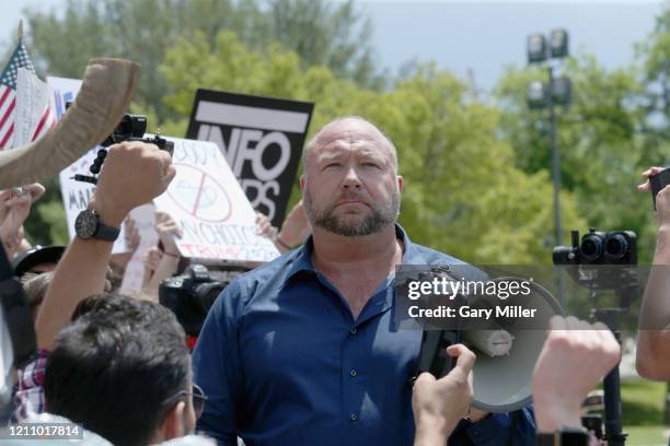 Alex Jones speaks to protestors gathered outside the Texas State Capitol during a rally calling for the reopening of Austin and Texas on April 25,...