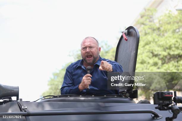 Alex Jones attends a protest outside the Texas State Capitol during a rally calling for the reopening of Austin and Texas on April 25, 2020 in...