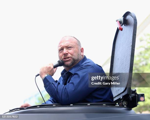 Alex Jones attends a protest outside the Texas State Capitol during a rally calling for the reopening of Austin and Texas on April 25, 2020 in...