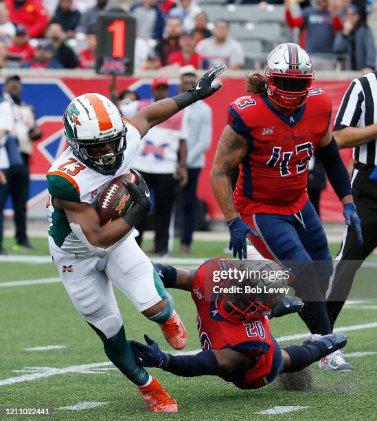 Trey Williams of the Seattle Dragons scores a touchdown in the second quarter as he breaks the tackle attempt by Marqueston Huff of the Houston...