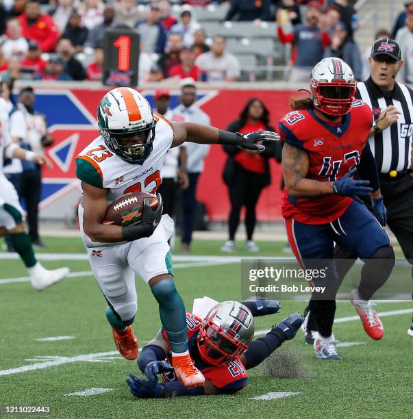 Trey Williams of the Seattle Dragons scores a touchdown in the second quarter as he breaks the tackle attempt by Marqueston Huff of the Houston...