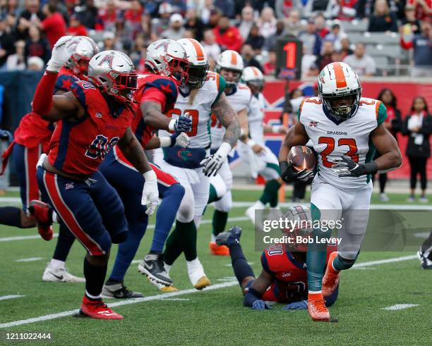 Trey Williams of the Seattle Dragons scores a touchdown in the second quarter as he breaks the tackle attempt by Marqueston Huff of the Houston...