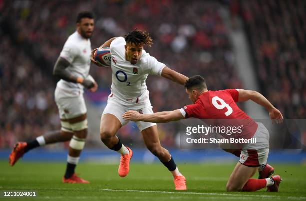 Anthony Watson of England avoids a tackle from Tomos Williams of Wales to score the first try during the 2020 Guinness Six Nations match between...