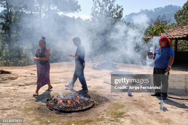 Shaman performing a Mayan healing ceremony for a family on the top of the Pascual Abaj hill, where the sacred stone is found. Some sources indicate...
