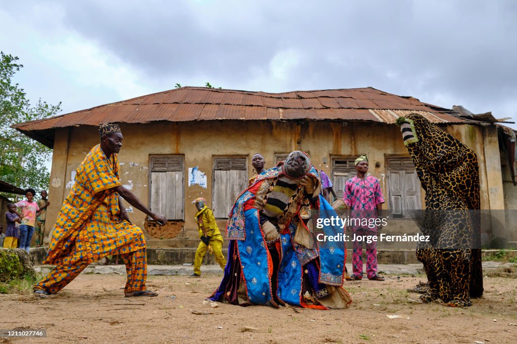 Man dressed with an Egungun mask performing during a ritual...