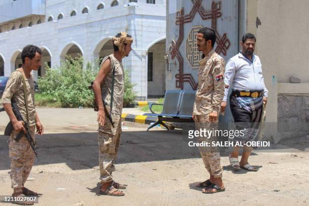 Fighters with Yemen's separatist Southern Transitional Council stand guard at the entrance of the Ministry of Finance's premises in the southern city...