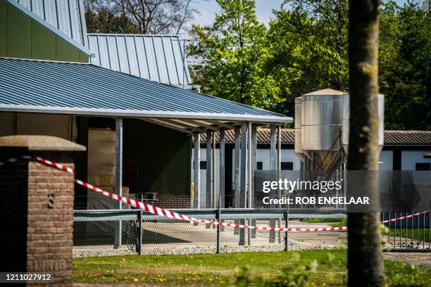 This general view shows barrier tape cordoning off buildings of a mink farm at Beek en Donk, eastern Netherlands on April 26 after tests showed that...