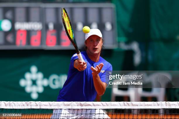 Henri Kontinen of Finland returns the ball during the third match as part of day 2 of Davis Cup World Group I Play-offs at Club Deportivo La Asuncion...