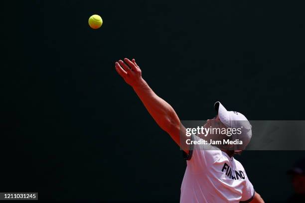 Harri Heliovaara of Finland serves during the fourth match as part of day 2 of Davis Cup World Group I Play-offs at Club Deportivo La Asuncion on...