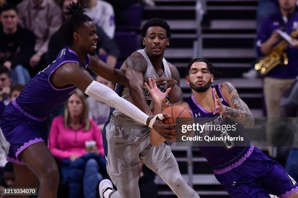 Izaiah Brockington of the Penn State Nittany Lions and Boo Buie of the Northwestern Wildcats battle for the basketball in the first half at...