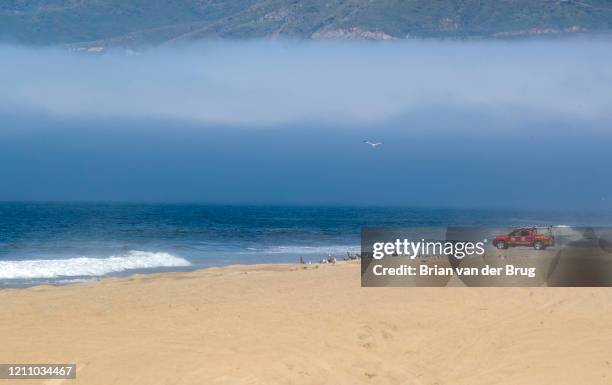 Los Angeles County lifeguards were stationed along the closed beach at Zuma to help keep people off of closed Los Angeles County beaches on Saturday,...