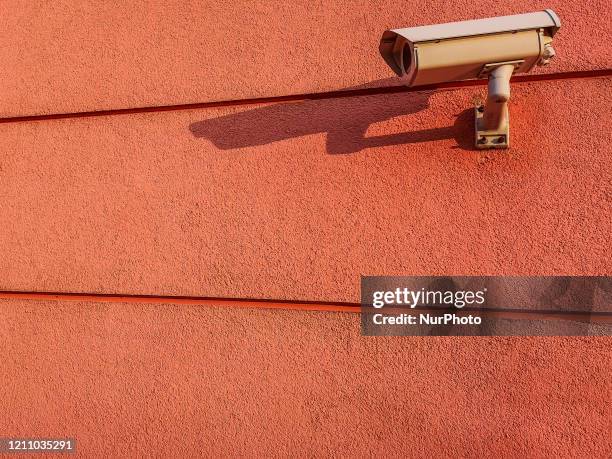 Surveillance camera hanging on a school wall is seen in Gdansk, Poland on 26 April 2020