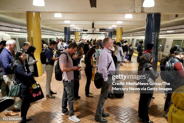 Afternoon commuters wait for their trains at Montgomery BART station in San Francisco, Calif., on Wednesday, March 4, 2020. Some commuters opted to...