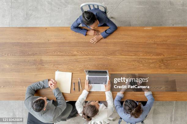 business team conducting an interview stock photo - people business meeting birdseye stock pictures, royalty-free photos & images