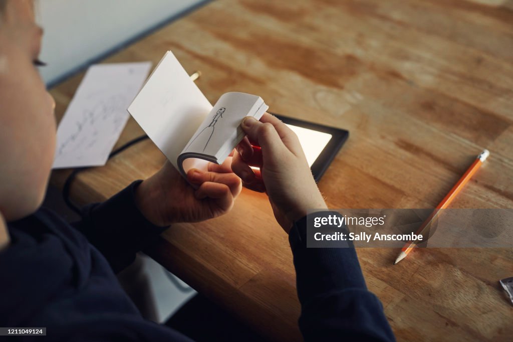Child drawing, making a flip book