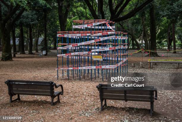 Tape is placed around a climbing frame that has been closed off to protect against the spread of Covid-19 coronavirus in a childrens play area in...