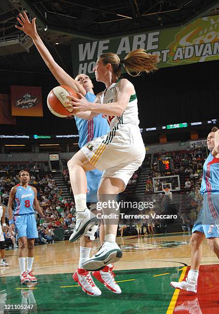 Katie Smith of the Seattle Storm looks to pass the ball against Alison Bales of the Atlanta Dream during the game on August 13, 2011 at Key Arena in...