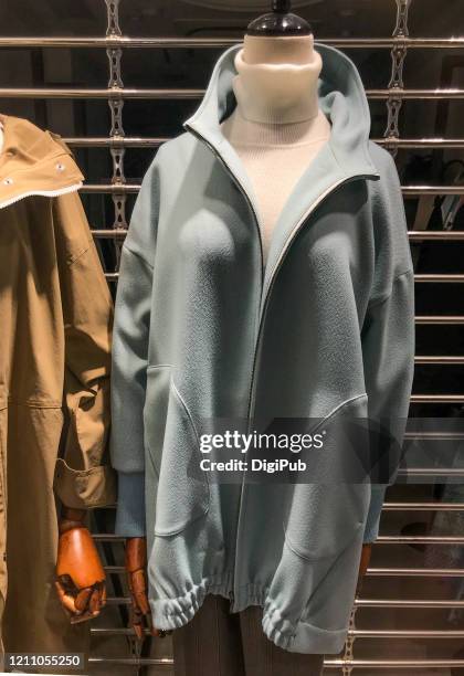 female like mannequin wearing sweater and coat - schneiderpuppe stock-fotos und bilder