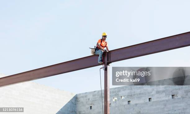 hispanic ironworker working on a steel girder - girder stock pictures, royalty-free photos & images