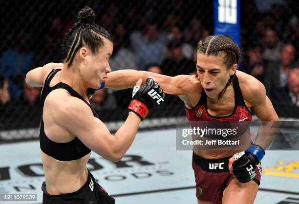 Joanna Jedrzejczyk of Poland punches Zhang Weili of China in their UFC strawweight championship fight during the UFC 248 event at T-Mobile Arena on...