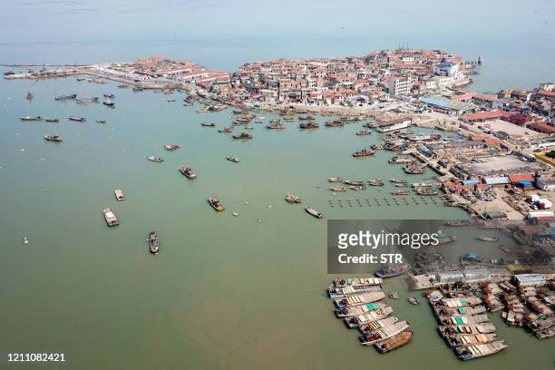 This aerial photo taken on April 27, 2020 shows fishing boats returning to a port in Lianyungang in China's eastern Jiangsu province, as they prepare...