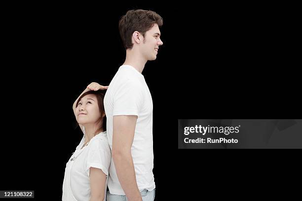 european and asian couple - short guy tall woman stock pictures, royalty-free photos & images