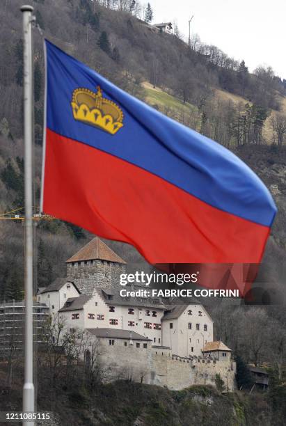 The Castel of Vaduz, home of the Liechtenstein princely family is pictured behind a Liechtenstein's flag on March 1, 2008 in Vaduz. Liechtenstein,...