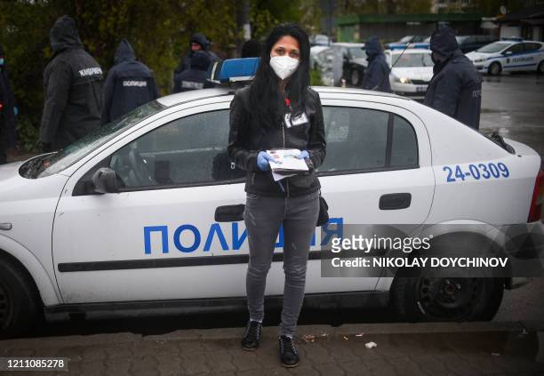 Maria Dimitrova a Roma Health mediator, poses for a picture in front of a police check point at the entrance of Fakulteta, the biggest Roma-populated...