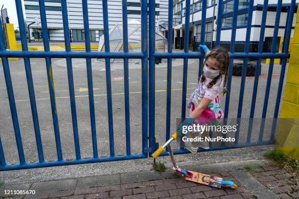 Girl plays with her scooter during the first day that the children are allowed to go out again after 42 days of mandatory quarantine decreed by the...