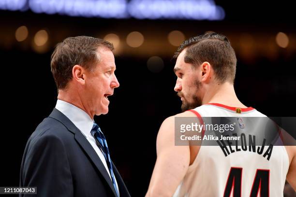 Head coach Terry Stotts of the Portland Trail Blazers chats with Mario Hezonja during the second half of the game against the Sacramento Kings at the...