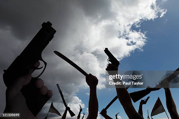armed rebellion with approaching storm - arma de fogo imagens e fotografias de stock