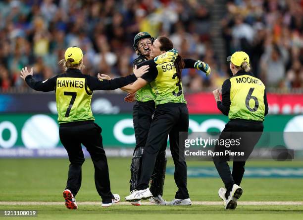 Megan Schutt and Alyssa Healy of Australia celebrate after taking the wicket of Shafali Verma of India during the ICC Women's T20 Cricket World Cup...
