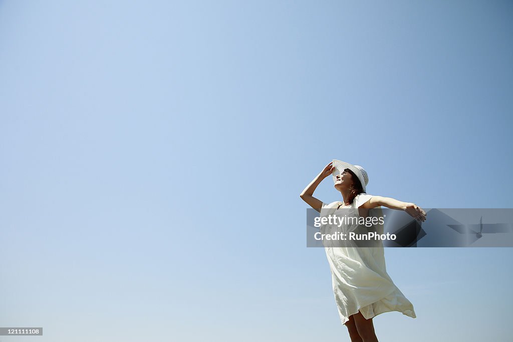 Young woman wearing a straw hat under the sun