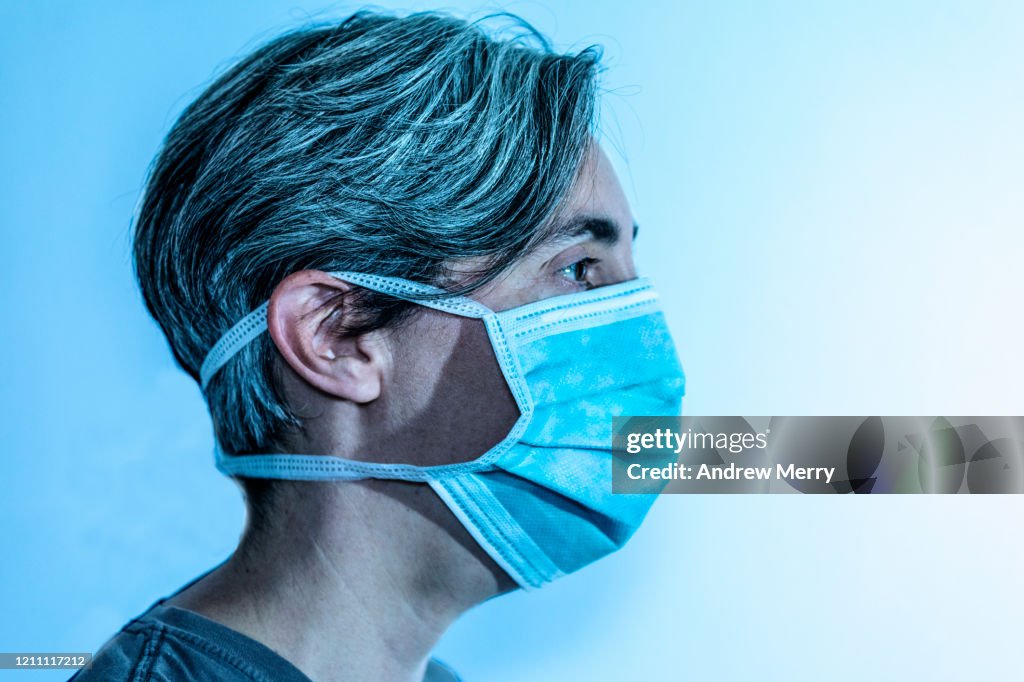 Woman wearing a surgical mask, protective face mask against infectious diseases like coronavirus, COVID-19 and influenza