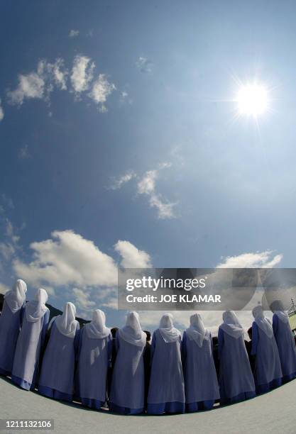 Ten Bosnian Muslim woman, symbolize 10 years anniversary of genocide, participate during the cultural program at the Memorial cemetery in Potocari,...